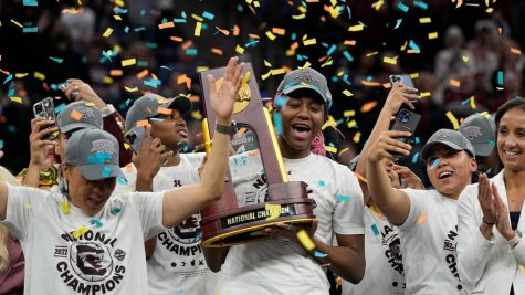 Star forward Aliyah Boston lifts up the NCAA Women’s National Championship trophy.